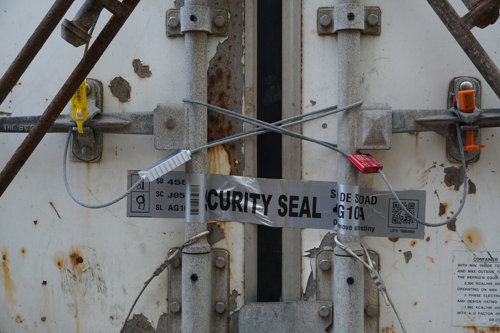 Silver security tape and metal seals use for seal cargo in transit shipping container.